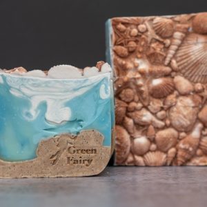 Soap slice that looks like the sand and the sea topped with sea shell details